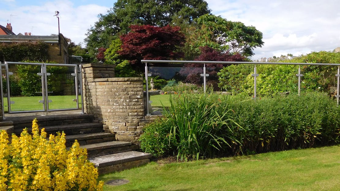 Stainless & glass balustrade install to household garden